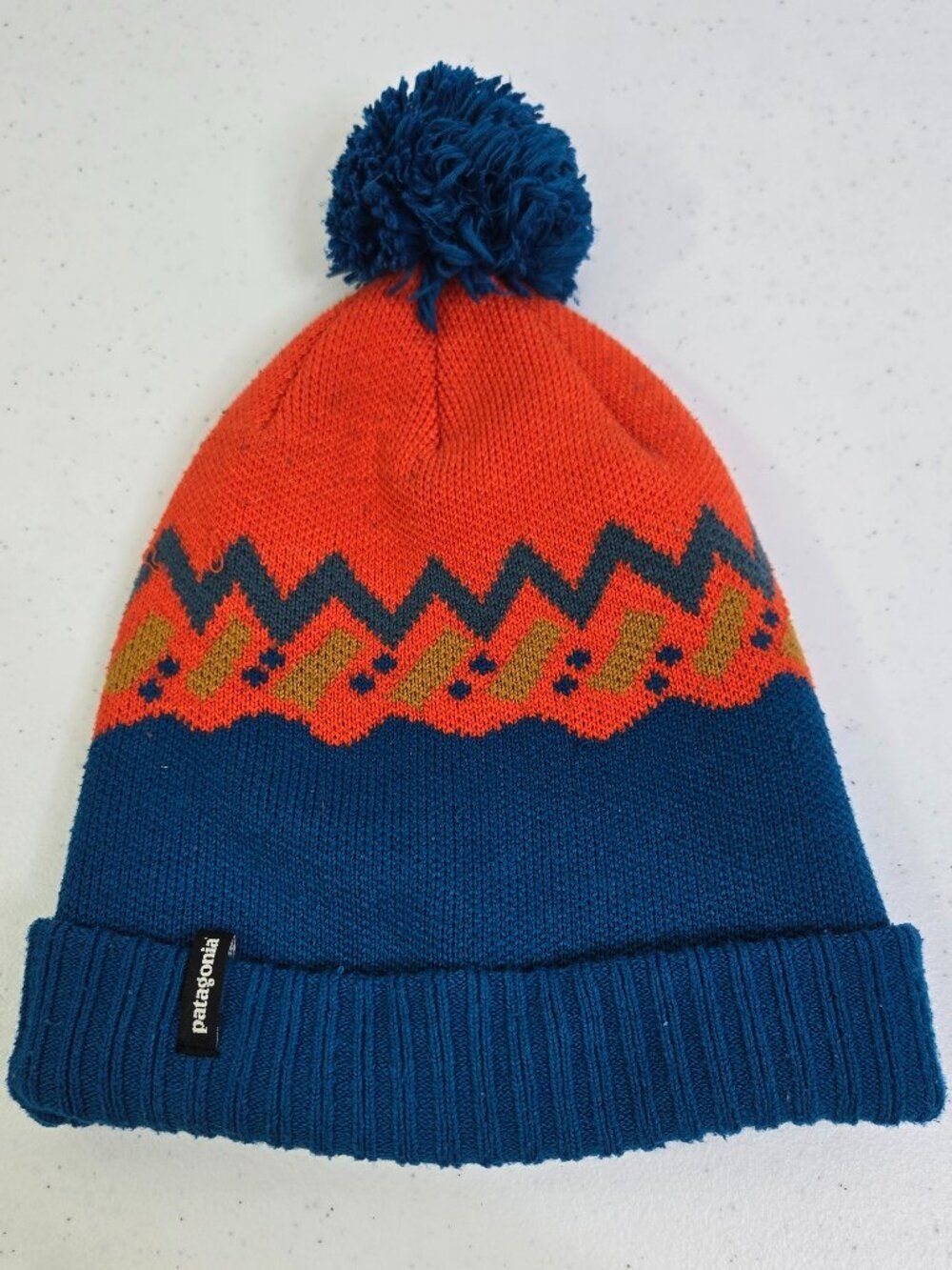 Patagonia Powder Town Beanie in the Lofoten Geo Knit Blue Orange Winter Pom Pom